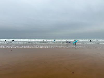 Surfers in the Atlantic waves off Taghazout Beach