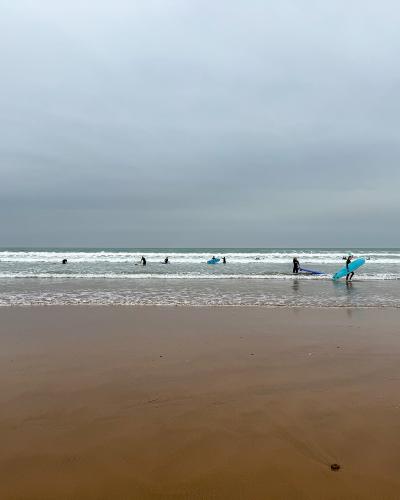 Surfers in the Atlantic waves off Taghazout Beach