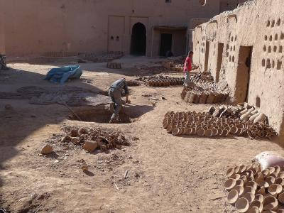 Pottery drying in the earthen courtyard of a traditional workshop in Tamegroute