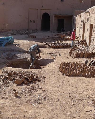 Pottery drying in the earthen courtyard of a traditional workshop in Tamegroute