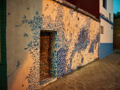A hand-painted wall and doorway in the Asilah medina, famous for its artists