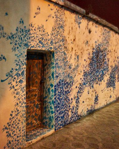 A hand-painted wall and doorway in the Asilah medina, famous for its artists